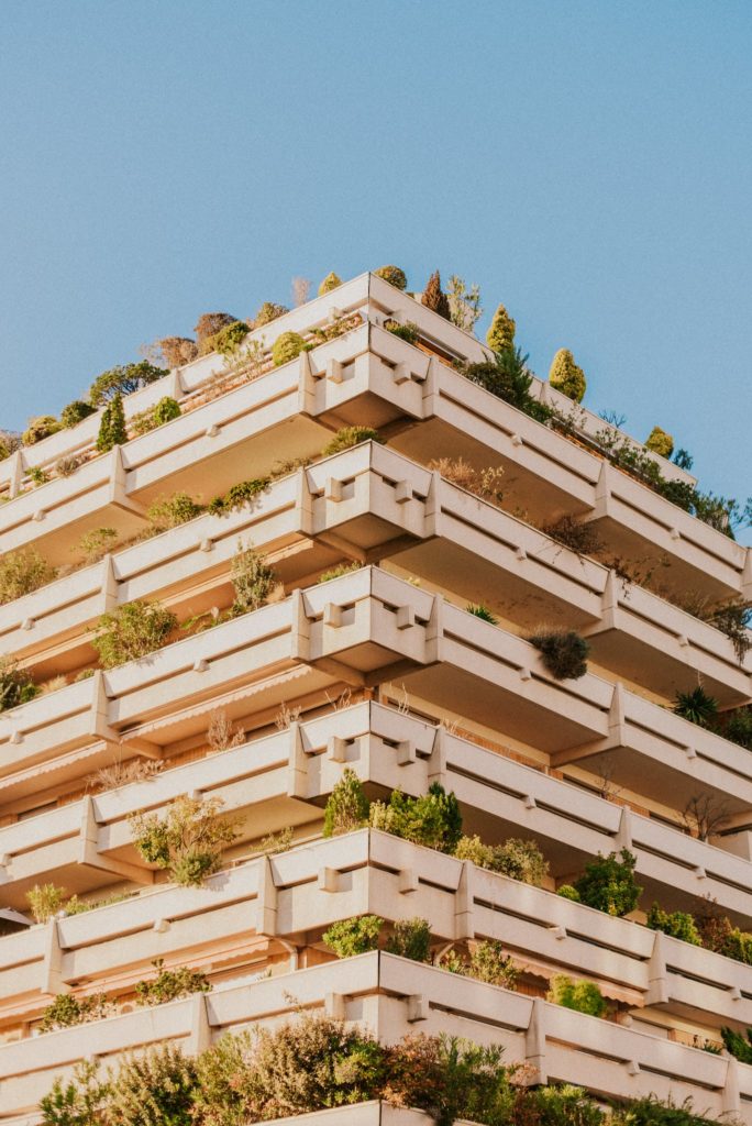 A tall building with plants growing on it